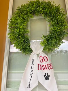 a wreath with the words go dawgs and a paw on it