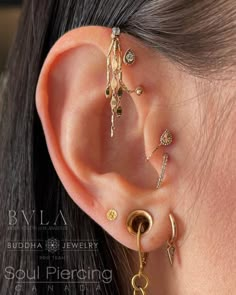 a woman wearing three different ear piercings