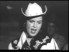 a woman wearing a cowboy hat and making a funny face