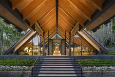 a large wooden building with stairs leading up to it