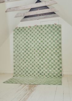 a green and white checkered wall in an attic