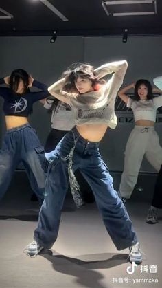 a group of young women are dancing together