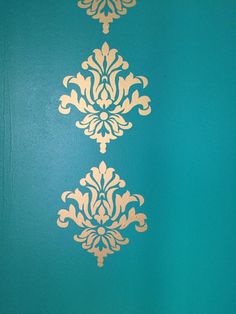 a blue wall with gold designs on it