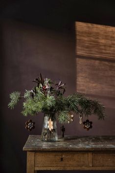 a vase filled with flowers sitting on top of a wooden table