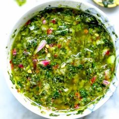 a white bowl filled with green vegetable soup