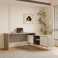 an office desk with a laptop on it in front of a potted bamboo plant