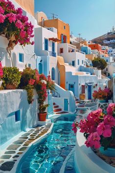 an outdoor swimming pool with flowers in the water and buildings on either side that have blue doors