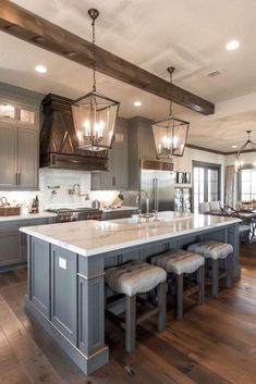 a large kitchen with an island in the middle and lots of counter space on one side