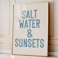 a framed poster with the words salt water and sunsets in blue ink on it