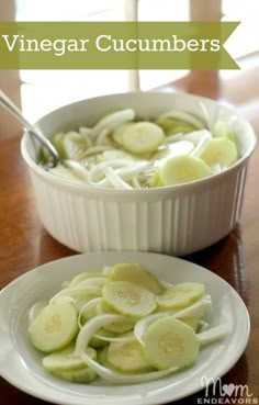 a white bowl filled with sliced cucumbers on top of a wooden table next to a