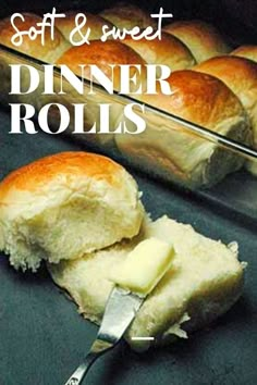 a loaf of bread sitting on top of a counter next to a pan filled with rolls