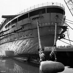 an old photo of a large ship in the water with ropes on it's sides