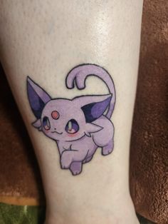 a small tattoo on the leg of a person with a pokemon pikachu design