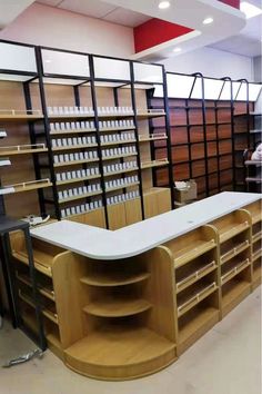 an empty counter in a store with lots of shelves