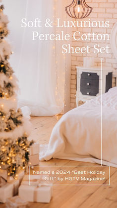 a white bed sitting next to a christmas tree