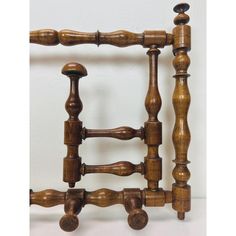 an old fashioned wooden bed frame with four posts and knobs on each end,