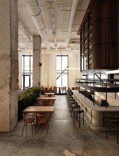 an empty restaurant with wooden tables and chairs