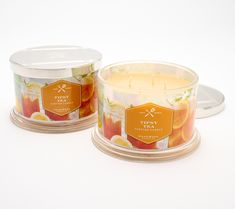 two candles sitting next to each other on a white surface