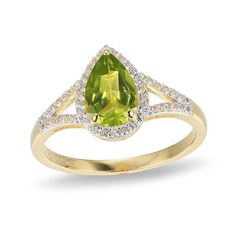 Experience the elegance of this spring-green peridot and white lab-created sapphire fashion ring. Sterling silver with 18K gold plate. The ring showcases a 9.0 x 6.0mm pear-shaped peridot center stone. White lab-created sapphires border the peridot and line the ring's split shank. Split Shank Ring, White Lab, Peridot Ring, Green Peridot, Split Shank, Fashion Ring, Spring Green, Ring Sterling Silver, Pear Shaped