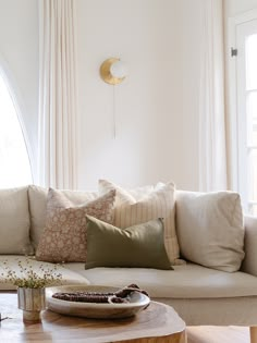 a living room with a couch, coffee table and window