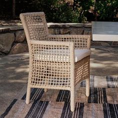 a wicker chair sitting on top of a rug