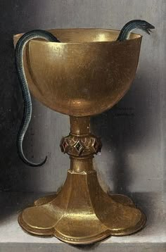 a gold cup with a snake on it