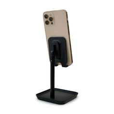 a cell phone is attached to a stand with a black holder for the charging device