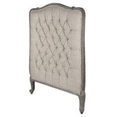 an old fashioned headboard with buttons on the top and bottom, in beige linen