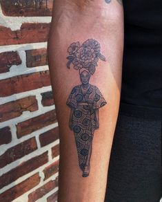 a tattoo on the arm of a person with flowers in her hair and an umbrella