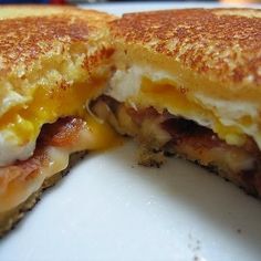 a grilled cheese and bacon sandwich cut in half