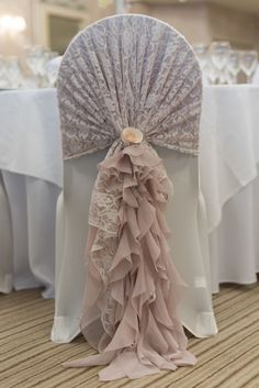 the back of a chair with ruffles on it at a banquet or wedding