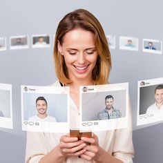 a woman looking at photos on her cell phone while holding it up to the camera