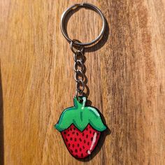 a key chain with a strawberry on it