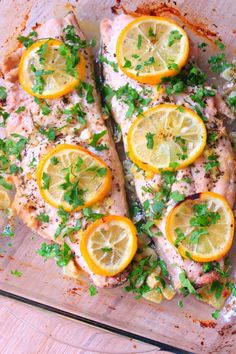 fish with lemons and parsley in a baking dish