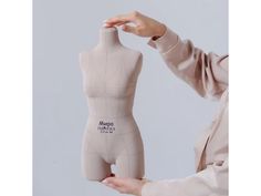 a female mannequin is shown holding it up