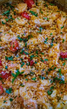 a pot filled with rice and shrimp covered in parmesan sprinkles