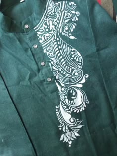 a green shirt with white designs on it