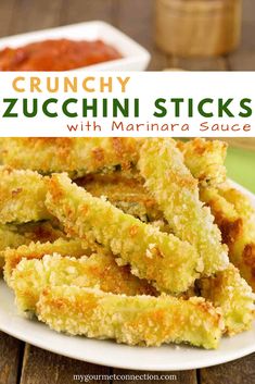 fried zucchini sticks on a white plate next to a bowl of chili sauce