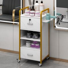 a white and gold cart with various items on it in front of a hairdresser's mirror