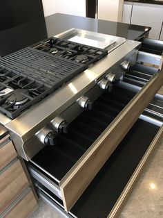 an open drawer in the middle of a stove