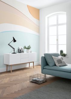 a living room with a blue couch and white walls