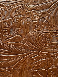 an intricately carved wooden surface with flowers and leaves