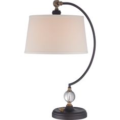 a table lamp with a white shade on the base and a black metal frame around it