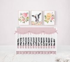 a baby's room with two pictures on the wall and a pink crib