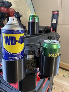 a can of wd - 40 sits on top of a toolbox with other tools