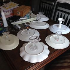 there are many plates and glasses on the table