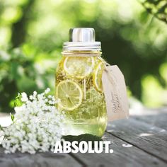 a jar filled with lemonade and some white flowers