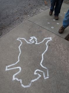 the sidewalk has been drawn with chalk and is next to a man walking on it