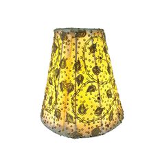 a yellow lamp shade with flowers and dots on it