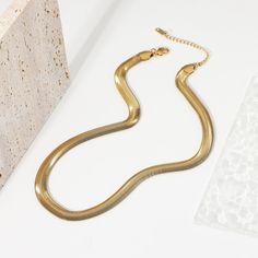 The Bold Herringbone Necklace in 18k gold plating makes a striking statement. Its wide, sleek design captures light beautifully, adding an element of sophisticated shine to any outfit, from casual to formal. Elegant Herringbone Clavicle Necklace, Elegant Metal Herringbone Clavicle Necklace, Sleek Gold Jewelry Gift, Sleek Gold Jewelry For Gifts, Sleek Gold Jewelry As A Gift, Sleek Gold Metal Jewelry, Elegant Metal Snake Chain Necklace, Elegant Formal Snake Chain Necklace With Adjustable Chain, Elegant Snake Chain Necklace With Adjustable Chain